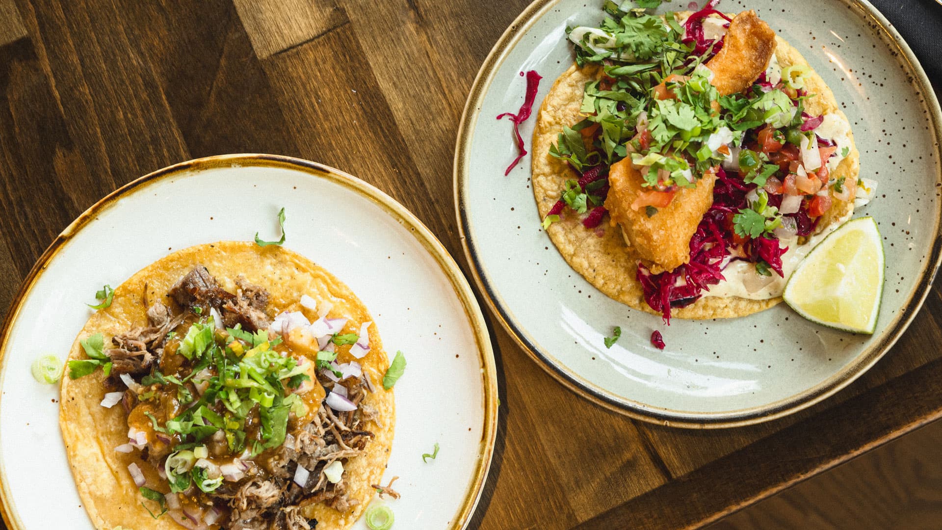 Tacos on handmade nixtamal tortillas, plated under warm light