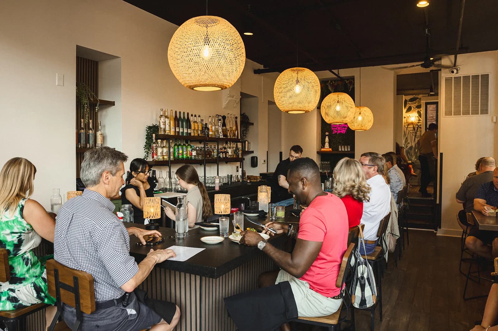 Guests eating and drinking at the bar at Crown Cantina during service