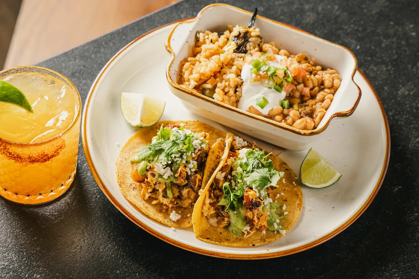 A taco spread with esquites, plated for a catering order