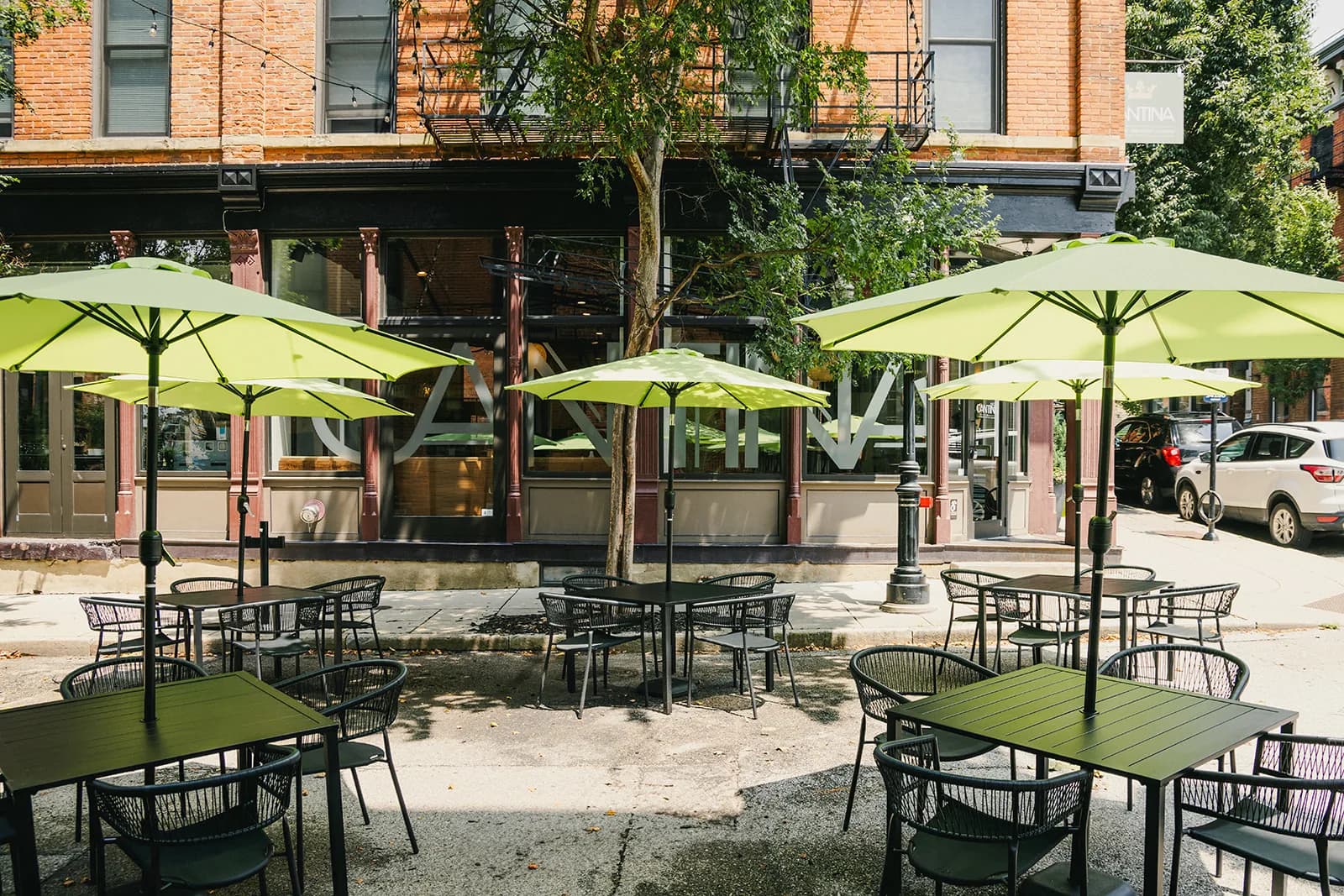 Crown Cantina's patio under its olive-green umbrellas